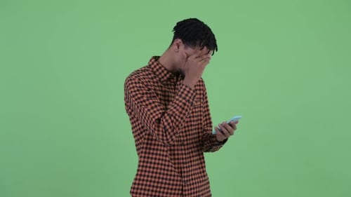 Man Reacts to Upsetting News on Cell Phone