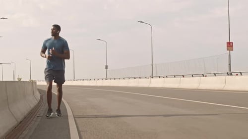 African-American Athlete Jogging on Road