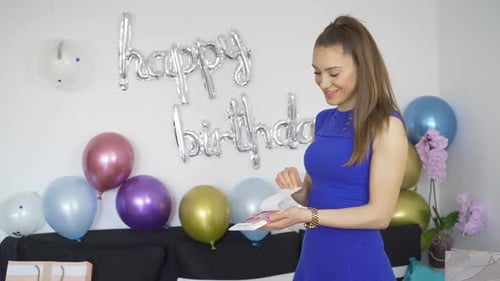 Woman Opens Birthday Card with Confetti Surprise