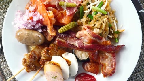 Delectable Buffet Plate Featuring Salmon, Bacon, and Sausage