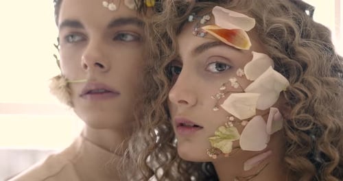 Tendet Young Couple with Floral Make Up Pose in Studio