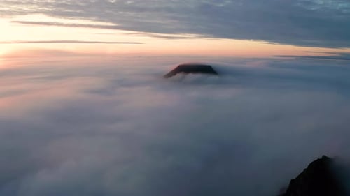 Aerial View of the Mountains in the Clouds at Sunset