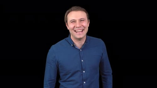 Man Laughing in Front of Black Background