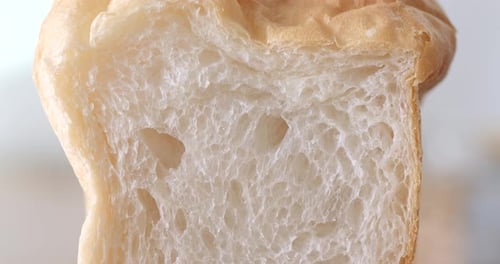 Hand pushing the white bread