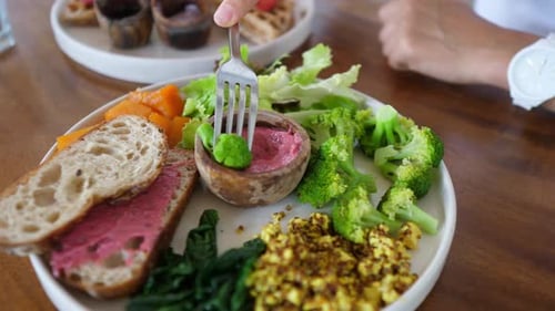 Person Eats Healthy Meal With Bread And Vegetables