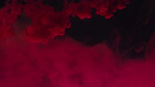 Expanding Cloud of Red Ink on Black Background