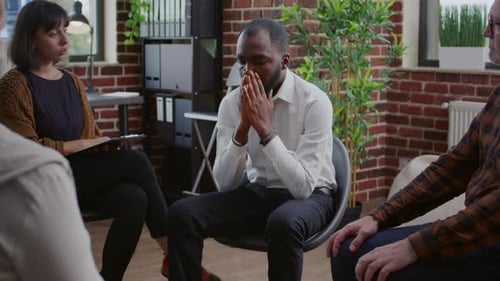 Adult Man Feeling Distressed in Therapy Group