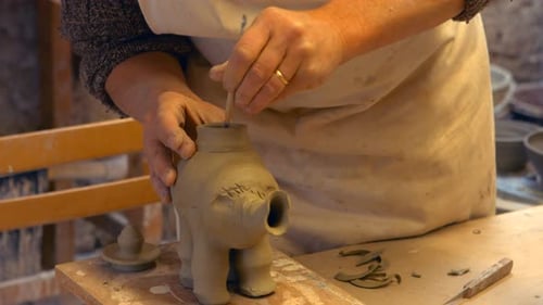 Potter Shaping Clay Vase in Studio Close Up