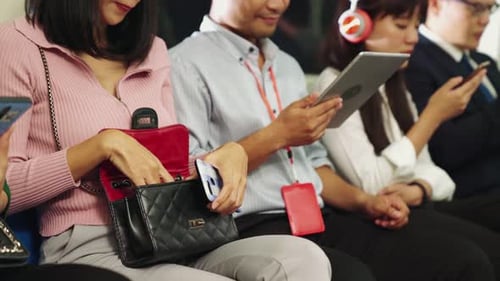 People Commuting While Using Mobile Phones and Tablets