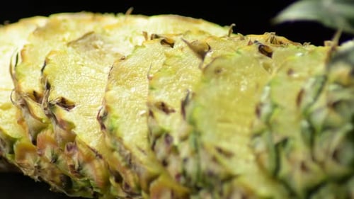 Sliced Pineapple Close Up on Black Background
