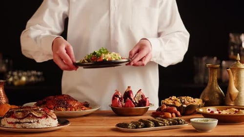 Placing Delicious Salad on Table Filled with Food