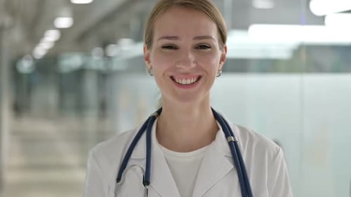 Female Doctor Smiling in Hospital Corridor