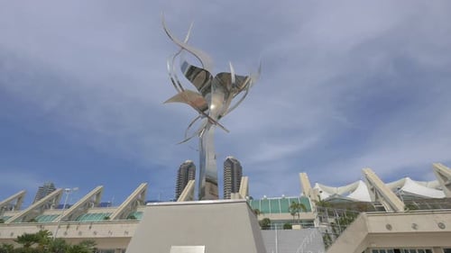 Metallic Sculpture in Urban Setting Under Blue Sky