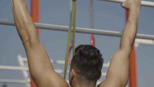 Man Doing Pull Ups in Outdoor Urban Gym