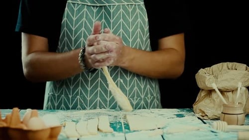 Baker Cutting and Rolling Dough for Cooking