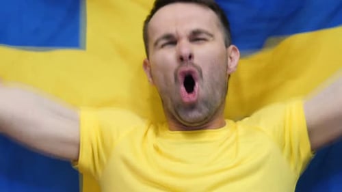 Adult Celebrates with Flag of Sweden