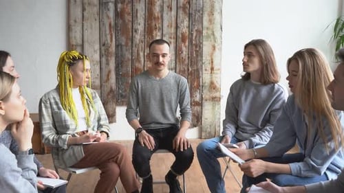 Group of Young Adults Meeting in Circle Indoors