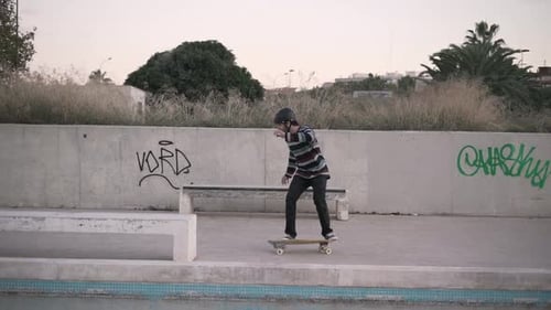 Hipster man skating in city