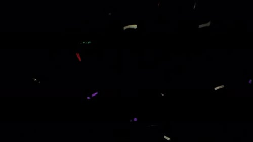 Colorful Tinsel Lametta Confetti Falling Down in Medum Wide Against Black With Alpha Channel