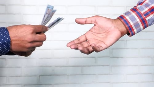 Close Up of Man Hand Giving Us Dollar Cash