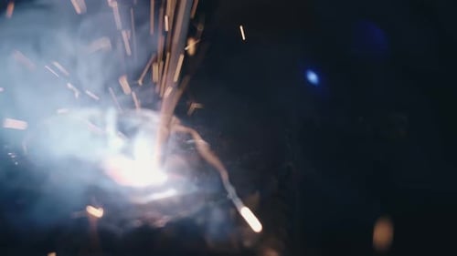 Intense Welding Sparks and Smoke Close-Up