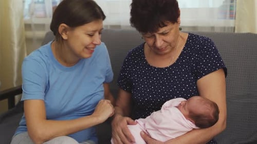 Generations Bonding Over Newborn Baby at Home