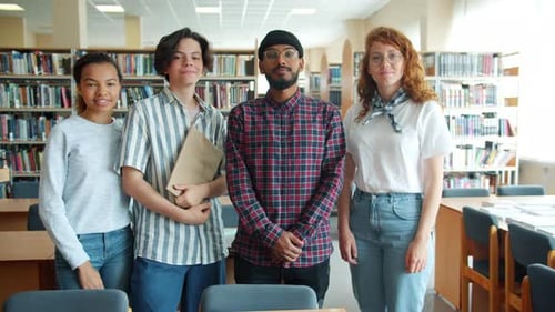 Slow Motion Portrait of Joyful Students Standing in Library Holding Books