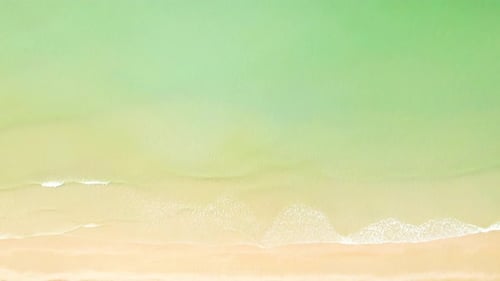 4K Aerial view top view of drone, sea waves and beautiful sand beach.