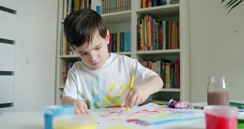 Child Draws at Table in Home Environment