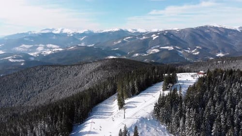 Aerial Ski Slopes with Skiers and Ski Lifts on Ski Resort. Snowy Mountain Forest