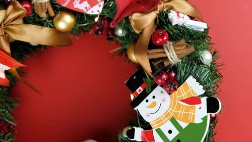 Festive Christmas Wreath with Ornaments on Red Background