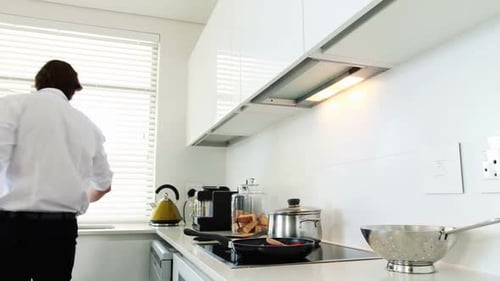 Man Cooking Pasta in Modern Kitchen