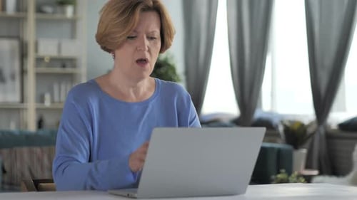 Woman Coughs While Using Laptop at Home