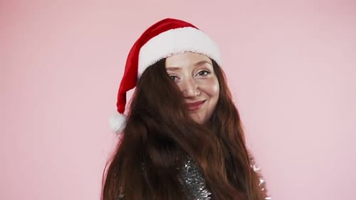 Woman Smiles Wearing Christmas Santa Hat