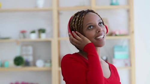 Young Woman Listening to Music with Headphones Indoors