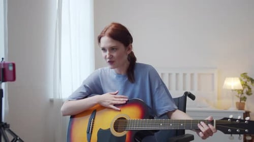 Woman in Wheelchair Plays Guitar for Video Stream