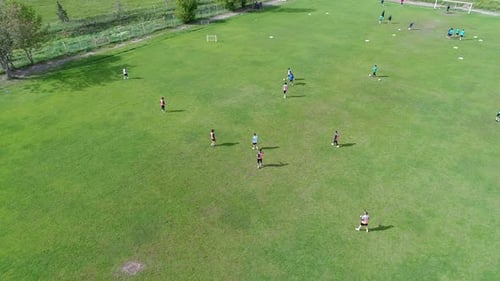 Aerial View of Soccer Players Practicing on Green Field