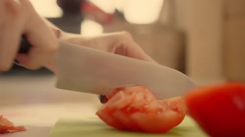 Slicing Fresh Tomato with Knife in Kitchen