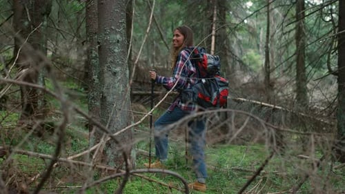 Woman with Backpack Trekking in Woods