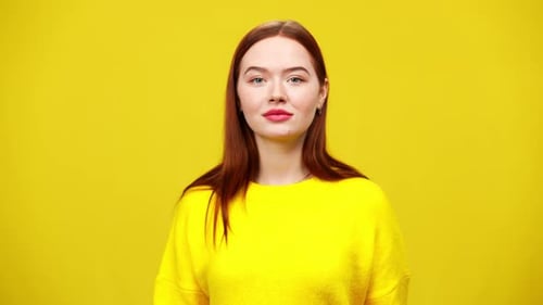 Auburn Haired Woman Smiling on Yellow Background