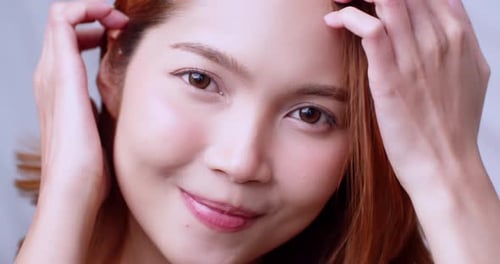 Young Asian woman in close up face portrait smile happy. Slow motion.