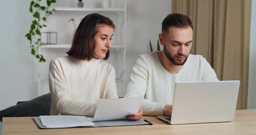 Man and Woman Working Together at Home