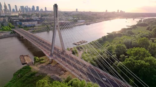 Aerial View of the Cable Bridge in the Sunset with City on the Background