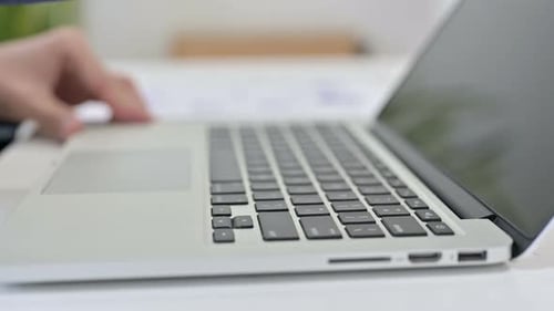 Businessman Opening and Typing on Laptop
