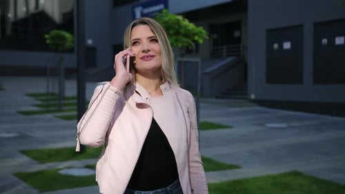 Woman Talking on Cell Phone in Urban Setting
