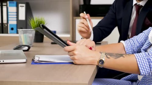 Business People Collaborating on a Tablet in Office