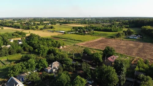 Aerial View of the Countryside and Small Village with Green Fields and Meadows