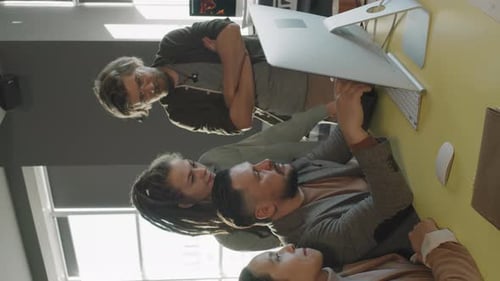Vertical Shot of Team of Business Colleagues Discussing Project