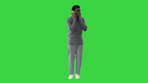 Young Man Dancing with Headphones on Green Screen