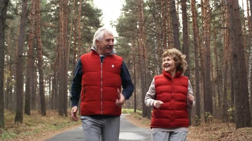 Senior Couple Jogging in Woods